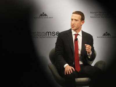 Mark Zuckerberg participates in a panel interview with spooky shadows in the foreground