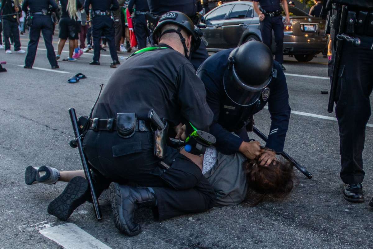 A Police officer arrests Lorises Tercero in front of the U.S. Courthouse during a protest demanding justice for George Floyd, Breonna Taylor and also in solidarity with Portland's protests, in downtown Los Angeles, California, on July 25, 2020.