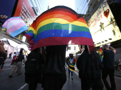 A protester holds a rainbow flag in support of transgender lives during a demonstration in Times Square against the police shooting of Roxanne Moore, a transgender woman.