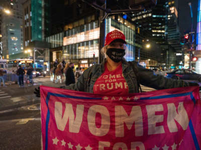 A supporter of Donald Trump holds a “Women for Trump” flag outside Trump Tower on November 3, 2020, in New York City.