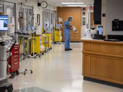 A healthcare professional suits up to enter a Covid-19 patient's room in the ICU at Van Wert County Hospital in Van Wert, Ohio, on November 20, 2020.