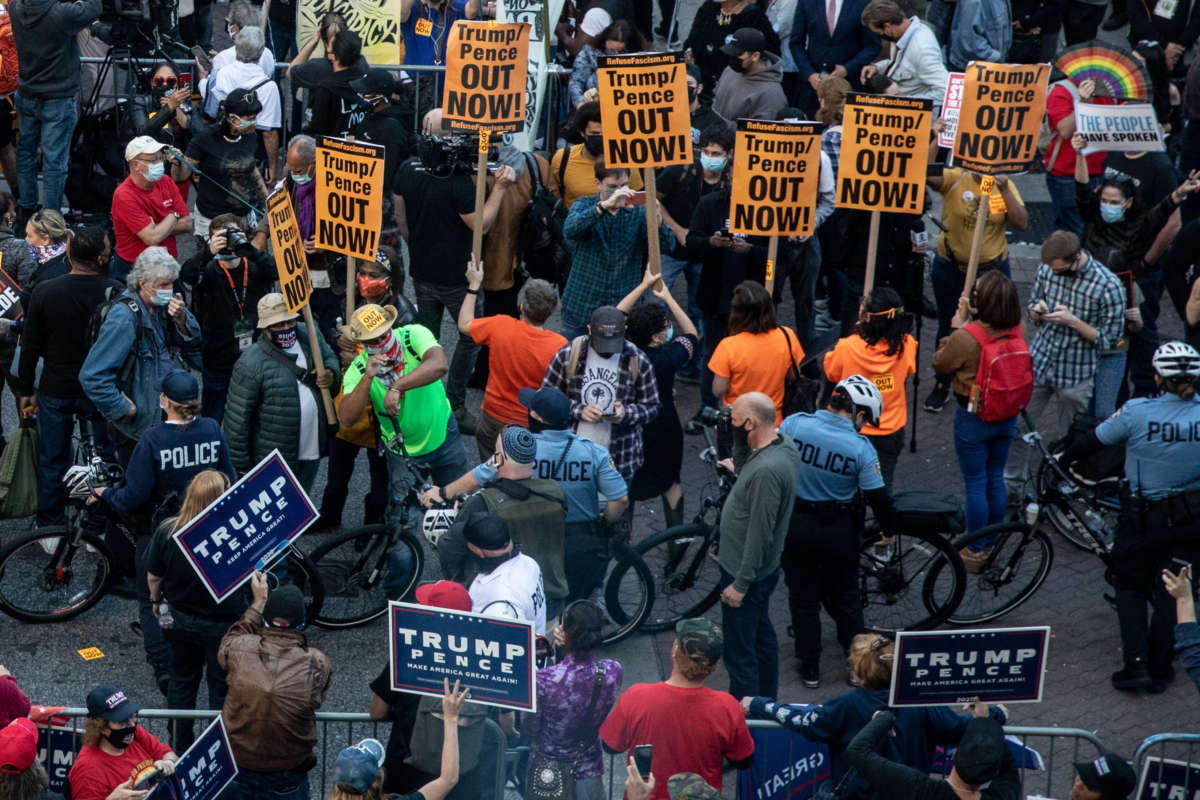 Police officers stand between protesters supporting U.S. President Donald Trump and people participating in a protest in support of counting all votes, outside of the Philadelphia Convention Center as the counting of ballots continues in the state on November 6, 2020, in Philadelphia, Pennsylvania.