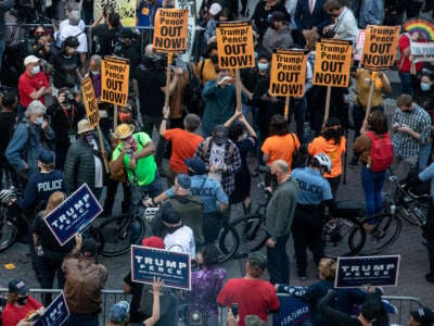 Police officers stand between protesters supporting U.S. President Donald Trump and people participating in a protest in support of counting all votes, outside of the Philadelphia Convention Center as the counting of ballots continues in the state on November 6, 2020, in Philadelphia, Pennsylvania.