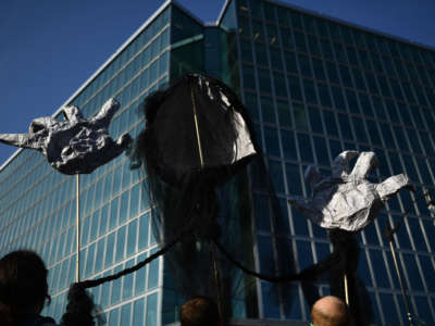 Environmental activists gather with puppet signs outside the American Petroleum Institute on September 23, 2019, in Washington, D.C.