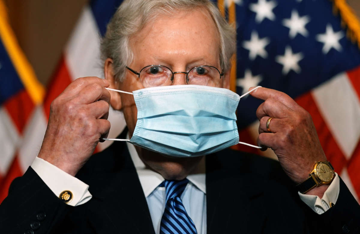 Senate Majority Leader Mitch McConnell puts on a mask after speaking to the media after the Republican's weekly senate luncheon in the U.S. Capitol in Washington, D.C., on December 8, 2020.