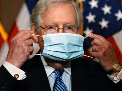 Senate Majority Leader Mitch McConnell puts on a mask after speaking to the media after the Republican's weekly senate luncheon in the U.S. Capitol in Washington, D.C., on December 8, 2020.