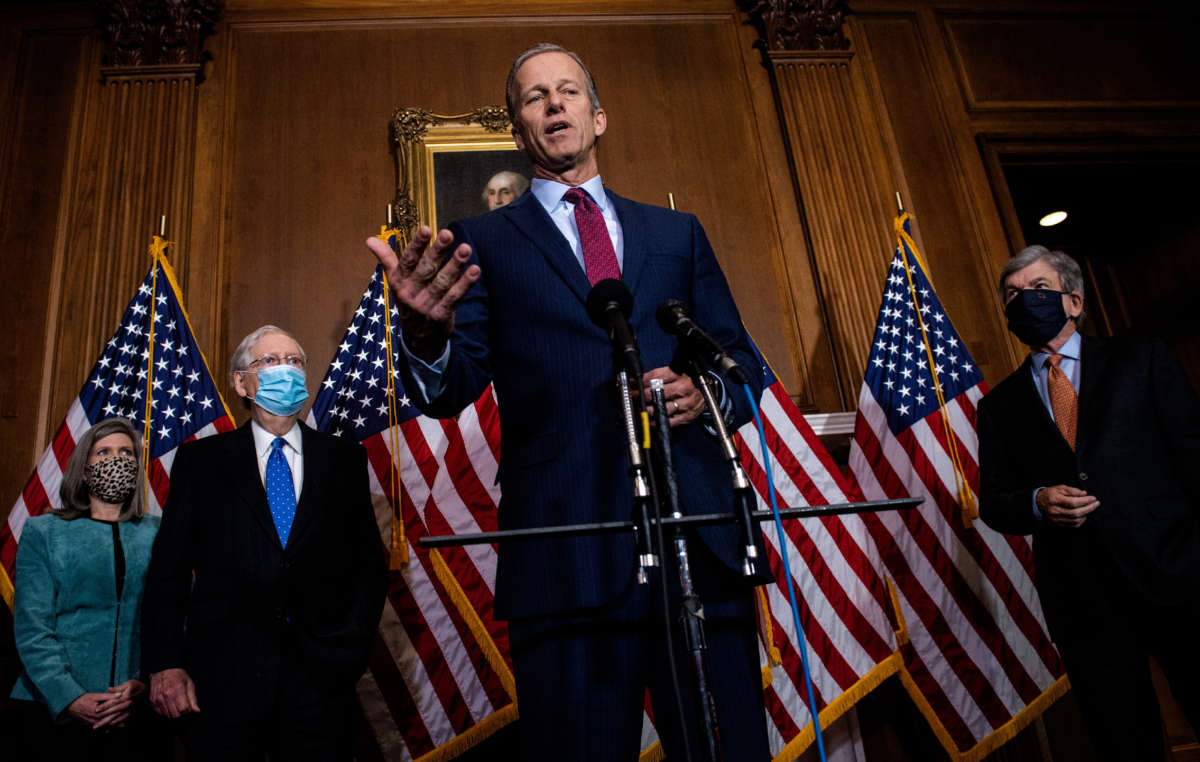 Sen. John Thune talks to reporters following the weekly Republican Senate conference meeting in the Mansfield Room at the U.S. Capitol on December 1, 2020, in Washington, D.C.