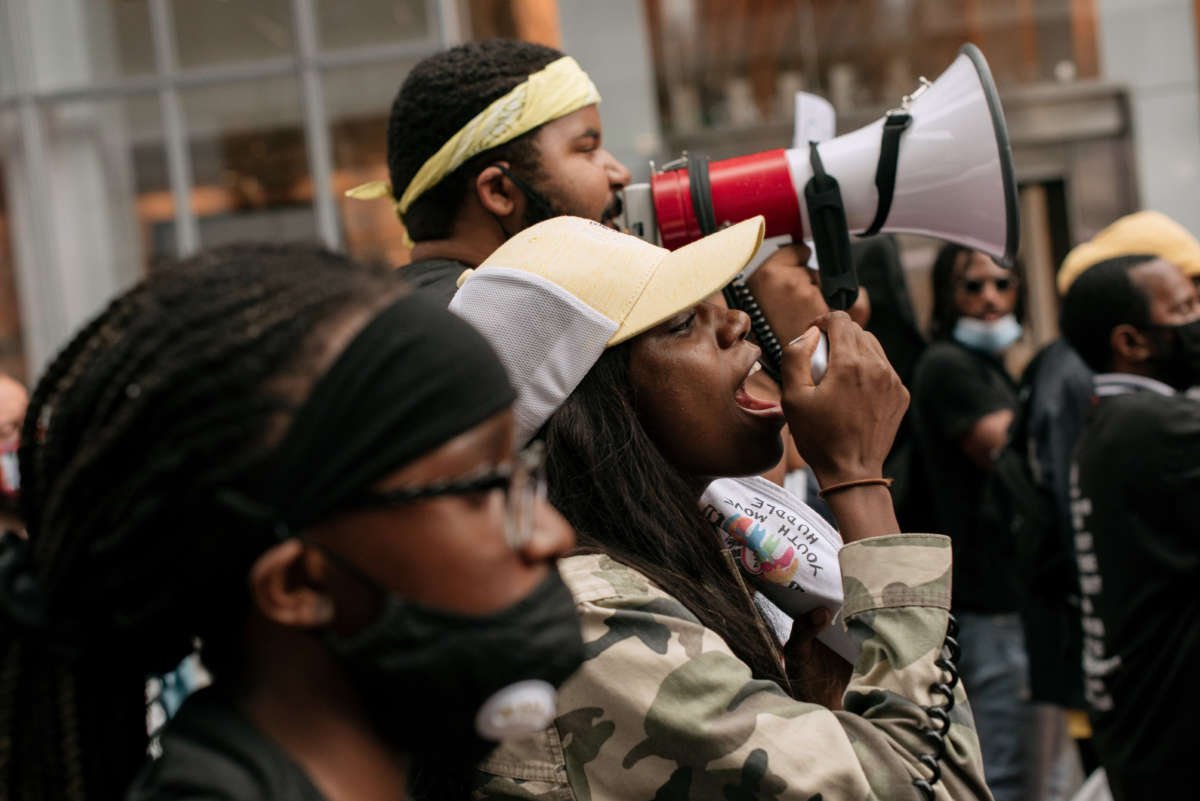 Protesters march with family members of victims of police brutality through Midtown Manhattan on July 31, 2020, in New York City.