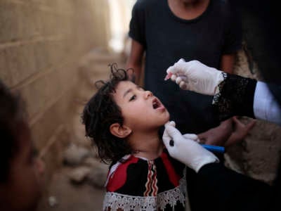 A small child receives a polio vaccine