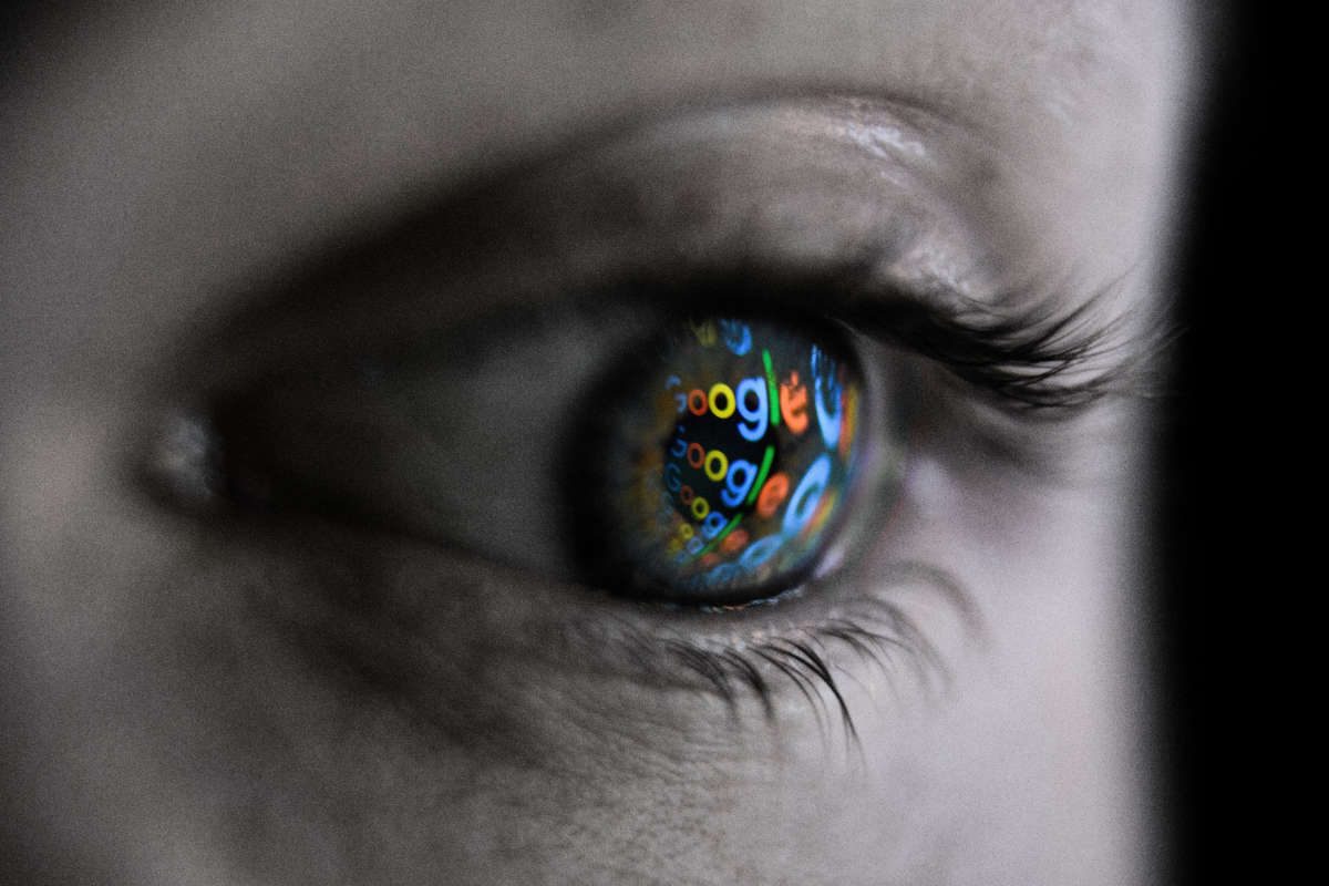Google logo reflected in person's eye