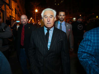 American political consultant Roger Stone walks through the crowd by his hotel as Trump supporters and Proud Boys held rally at night in Washington, D.C., United States on December 11, 2020.