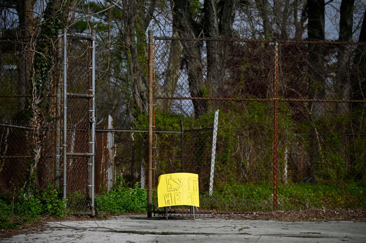 Sign informs parents who picked up items from the neighborhood public school to exit the premisses through the gate, in the Mt. Airy neighborhood of Philadelphia, Pennsylvania, on April 14, 2020.