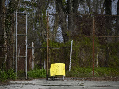 Sign informs parents who picked up items from the neighborhood public school to exit the premisses through the gate, in the Mt. Airy neighborhood of Philadelphia, Pennsylvania, on April 14, 2020.