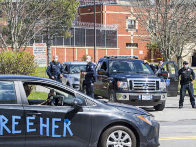 Prison staff block the entrances as a drive-by rally organized by Families for Justice as Healing moves around MCI Framingham, a women's prison hit hard by the coronavirus, in Framingham, MA on May 3, 2020.