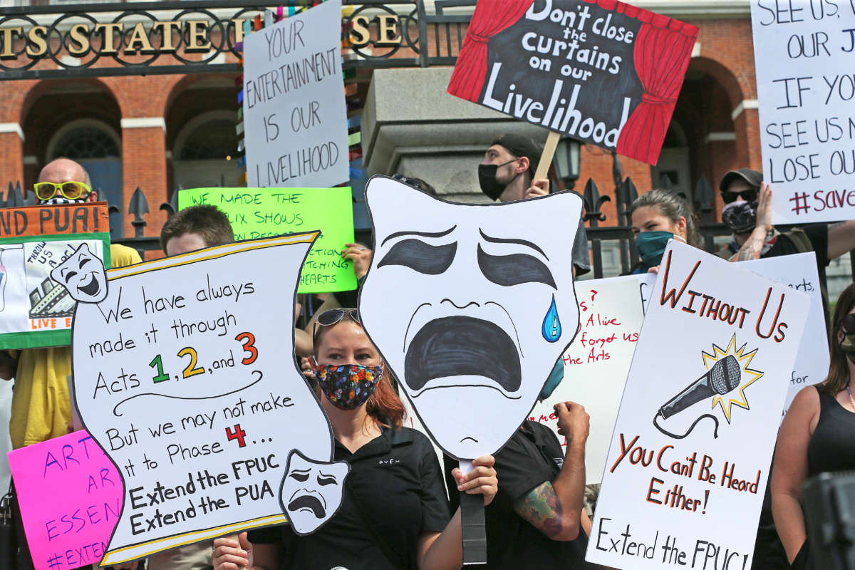 Performance artists rally in front of the the Massachusetts State House in Boston for extended FPUC, the extra $600 provided on top of unemployment during the COVID-19 pandemic, on July 20, 2020.