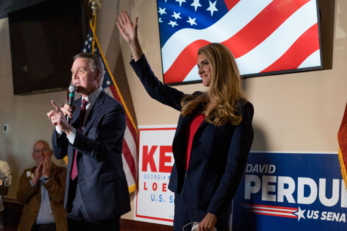 Sen David Perdue and Sen Kelly Loeffler speak at a campaign event to supporters at a restaurant on November 13, 2020, in Cumming, Georgia.