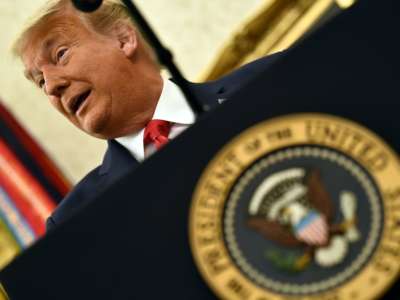 Donald Trump speaks before awarding the Presidential Medal of Freedom to retired football coach Lou Holtz on December 3, 2020, in the Oval Office of the White House in Washington, D.C.