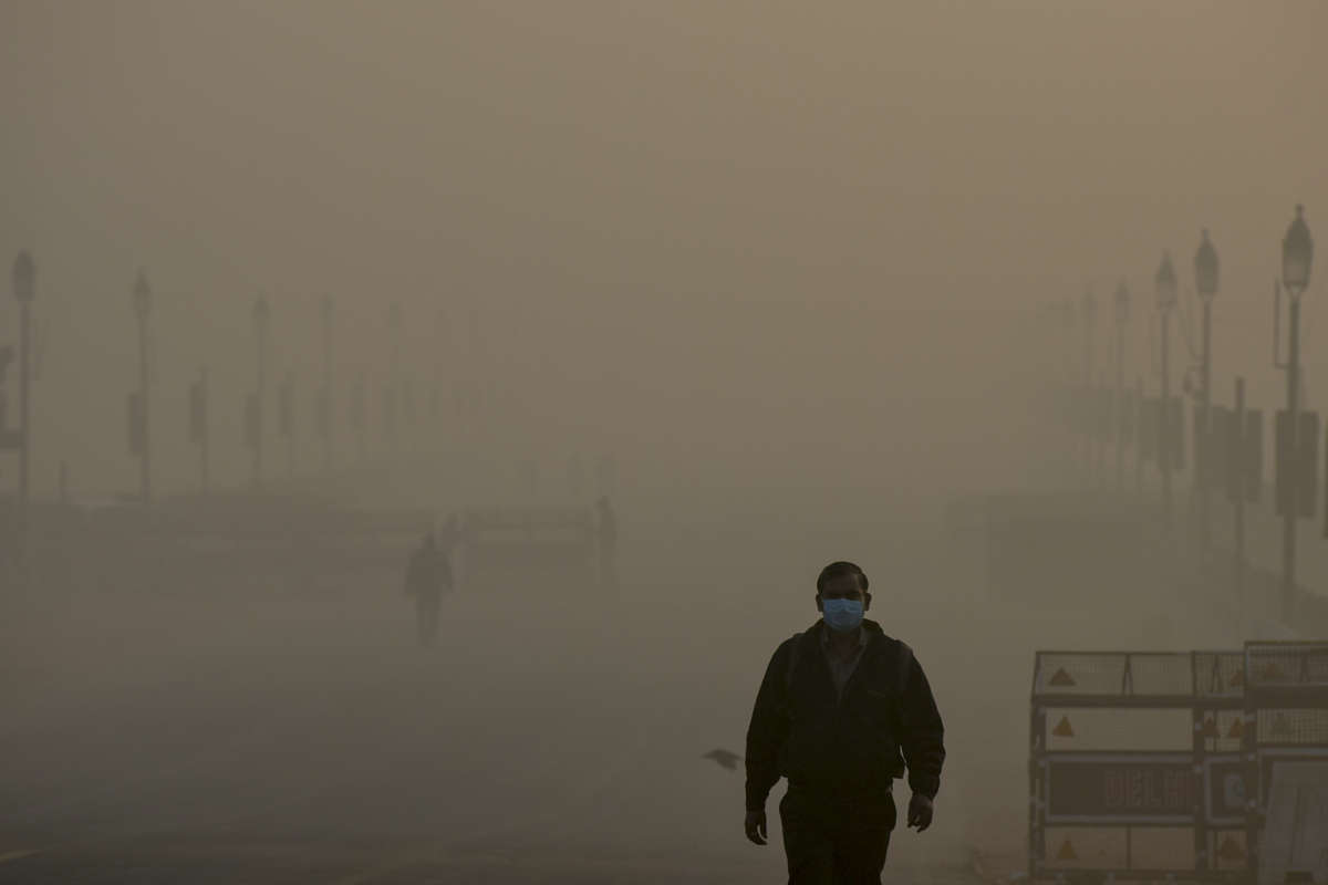 People near India Gate in the early hours of a smoggy morning at Rajpath on December 24, 2020, in New Delhi, India.