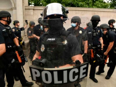 Denver Police officers watch over the crowd at Civic Center Park on July 19, 2020, in Denver, Colorado.