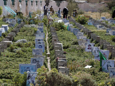 Yemeni relatives visit graves of their relatives who were killed in the ongoing Yemeni civil war at a cemetery on November 6, 2020 in Sana'a, Yemen.