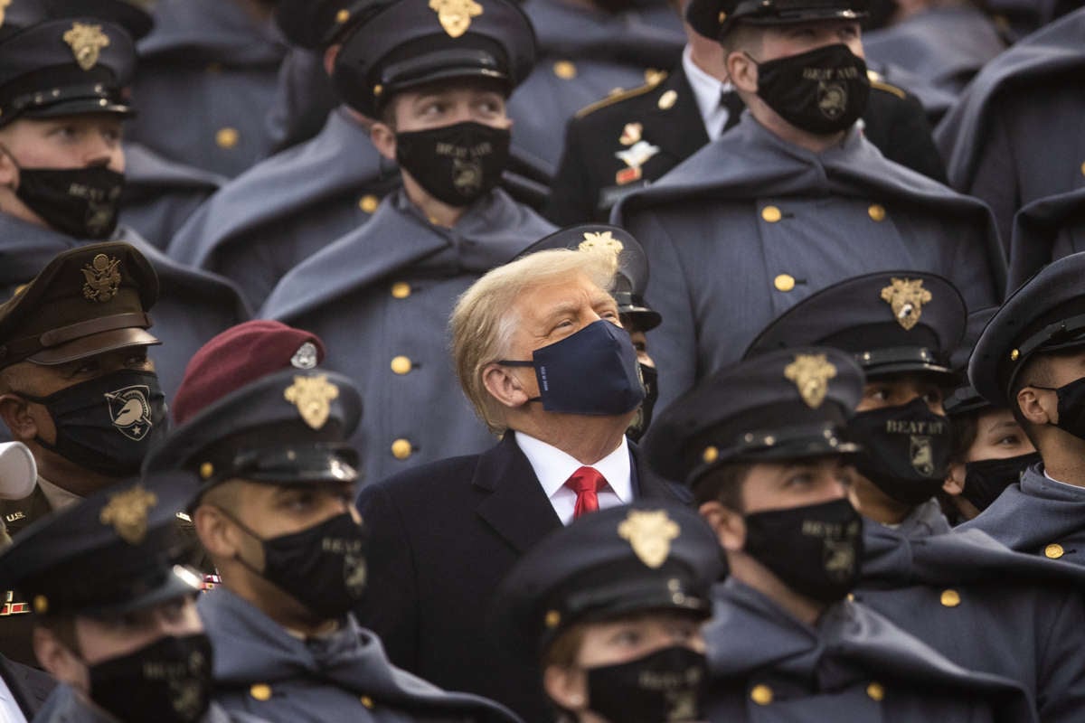 President Donald Trump sits with the United States Military Academy Corps of Cadets during the game between the Army Black Knights and the Navy Midshipmen at Michie Stadium on December 12, 2020, in West Point, New York.