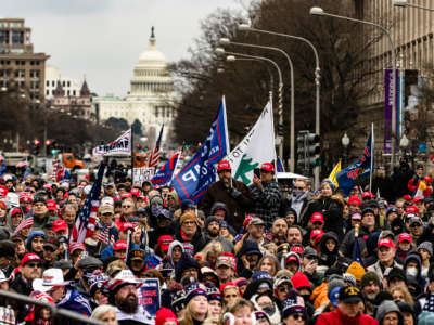 trump supporters march through the streets