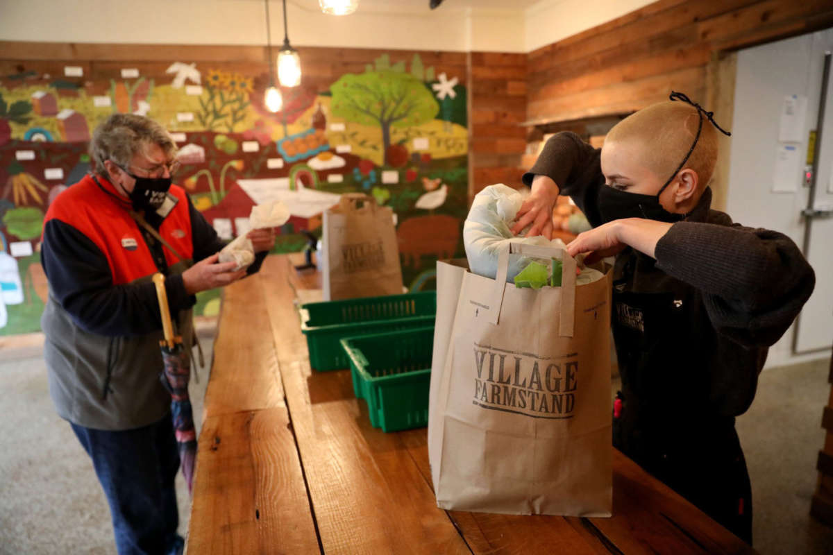 A cashier bags groceries