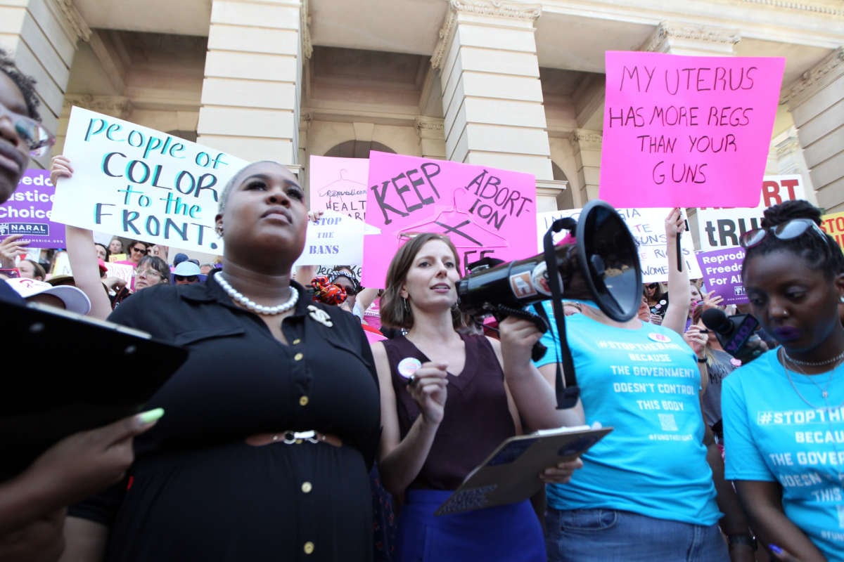 Abortion rights advocates including NARAL Georgia Director Laura Simmons (2nd-L) rally in front of the Georgia State Capitol in Atlanta to protest new restrictions on abortions that were passed in Georgia, on May 21, 2019.