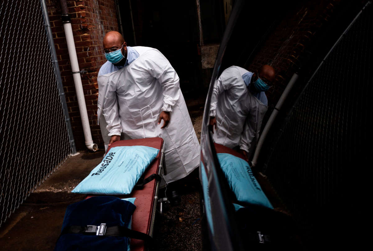 Maryland Cremation Services transporter Reggie Elliott folds up a spare gurney after bringing the remains of a COVID-19 victim to his van from the hospital's morgue in Baltimore, Maryland, on December 24, 2020.