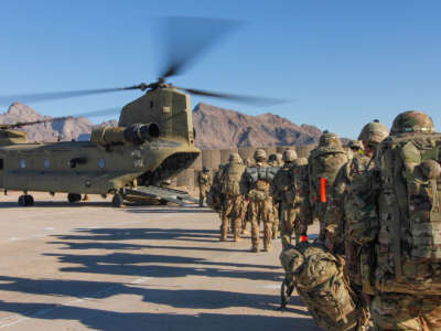 U.S. soldiers assigned to the 101st Resolute Support Sustainment Brigade load onto a Chinook helicopter to head out and execute missions across Afghanistan on January 15, 2019.