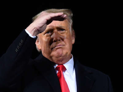 Trump shields his eyes