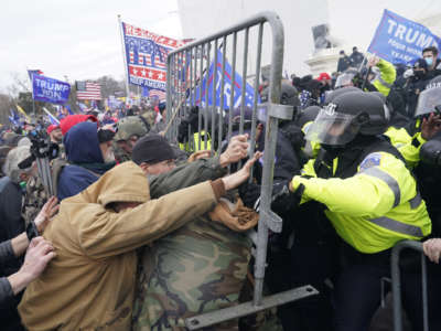 Trump loyalists fueled by President Trump's continued claims of election fraud clash with police on January 6, 2021, in Washington, D.C.