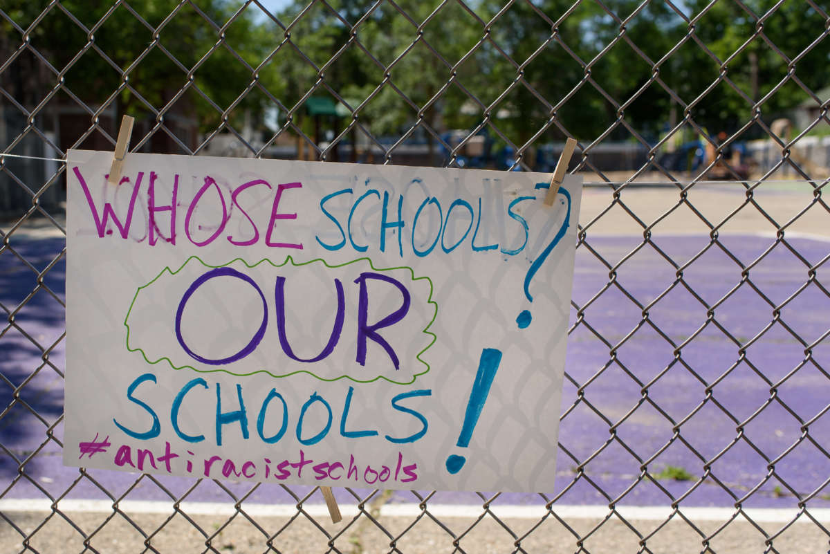 A child’s sign hangs on a school fence during a Day of Solidarity for Antiracist Schools in Madison, Wisconsin.