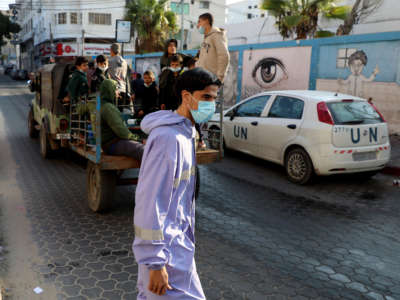 A UN employee, mask-clad due to the COVID-19 pandemic, is seen in Gaza City on November 10, 2020.