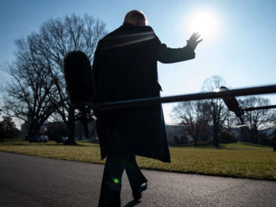 President Trump stops to talk to reporters as he walks to board Marine One and depart from the South Lawn at the White House on January 12, 2021, in Washington, D.C.