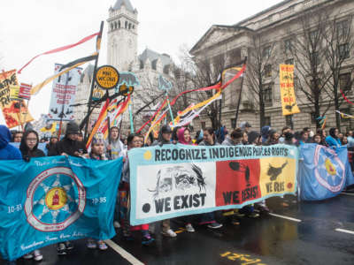 People march past Trump International Hotel during the Native Nations Rise protest on March 10, 2017, in Washington, D.C.