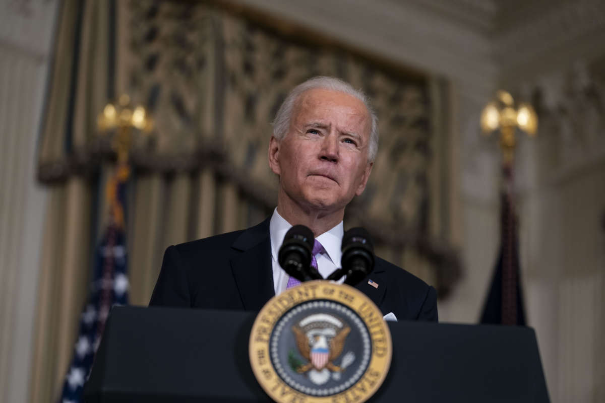 Joe Biden squints into the air while speaking at a podium