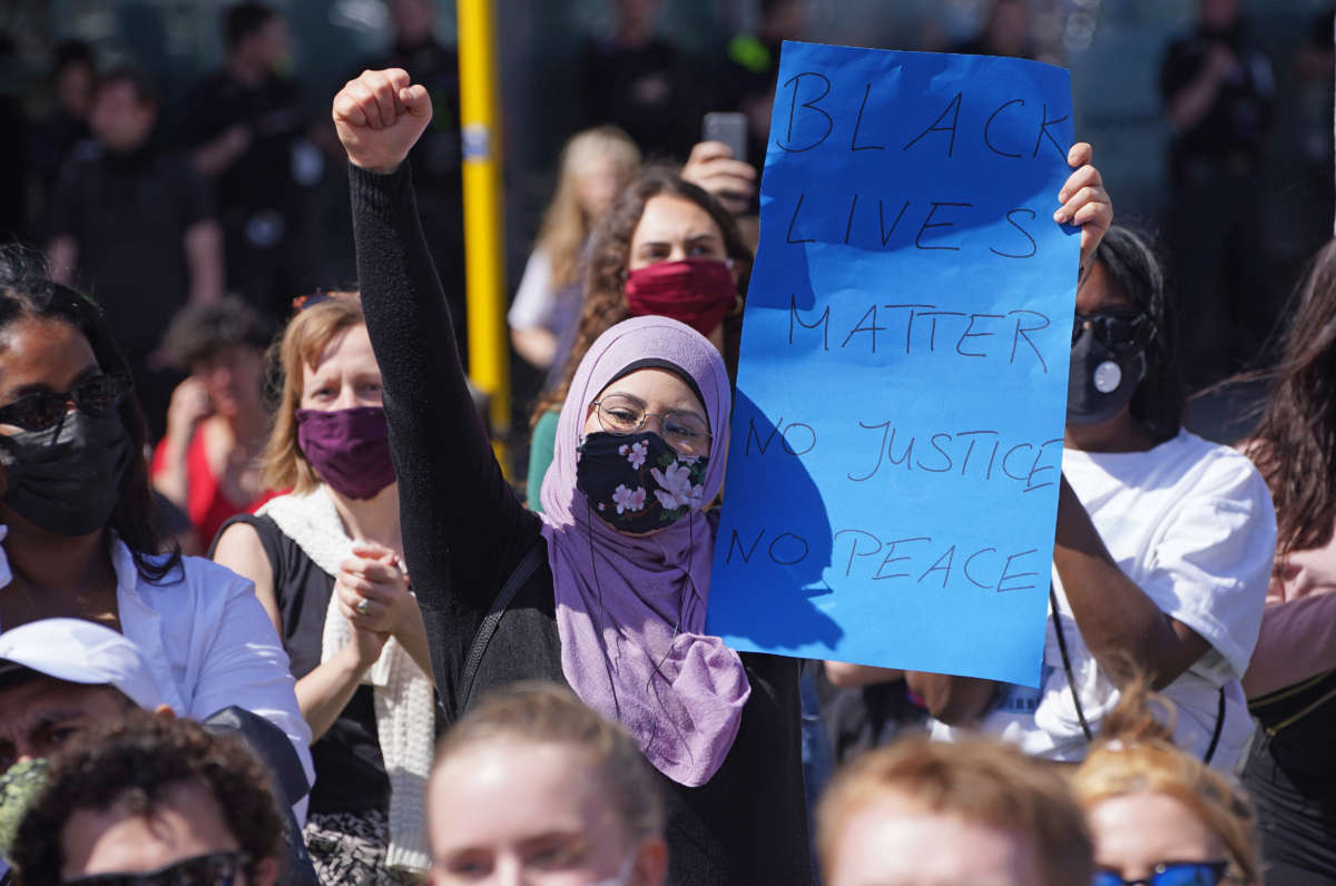 A young Muslim woman joins people attending a protest rally on May 31, 2020, in Berlin, Germany.