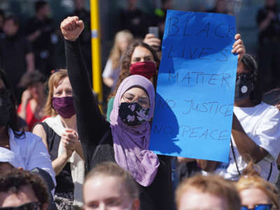 A young Muslim woman joins people attending a protest rally on May 31, 2020, in Berlin, Germany.