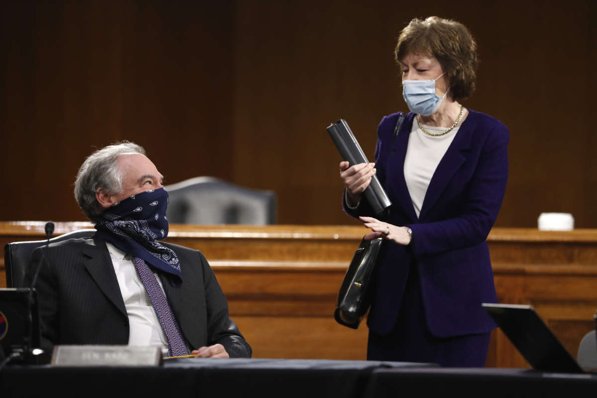 Sen. Tim Kaine speaks with Sen. Susan Collins before the Health, Education, Labor and Pensions Committee hearing on May 7, 2020 in Washington, D.C.