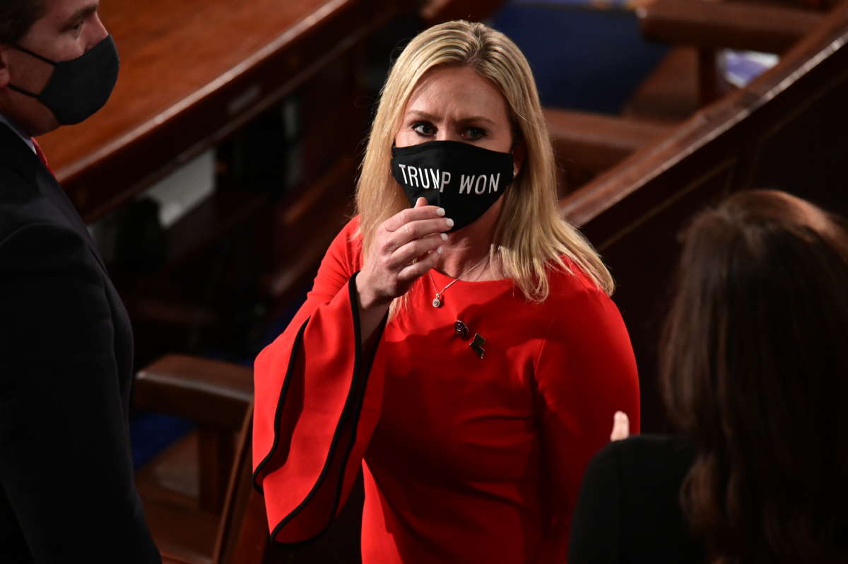 Rep. Marjorie Taylor Greene wears a "Trump Won" face mask as she arrives on the floor of the House to take the oath office on the year's opening session on January 3, 2021, in Washington, D.C.