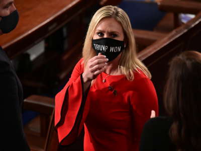 Rep. Marjorie Taylor Greene wears a "Trump Won" face mask as she arrives on the floor of the House to take the oath office on the year's opening session on January 3, 2021, in Washington, D.C.