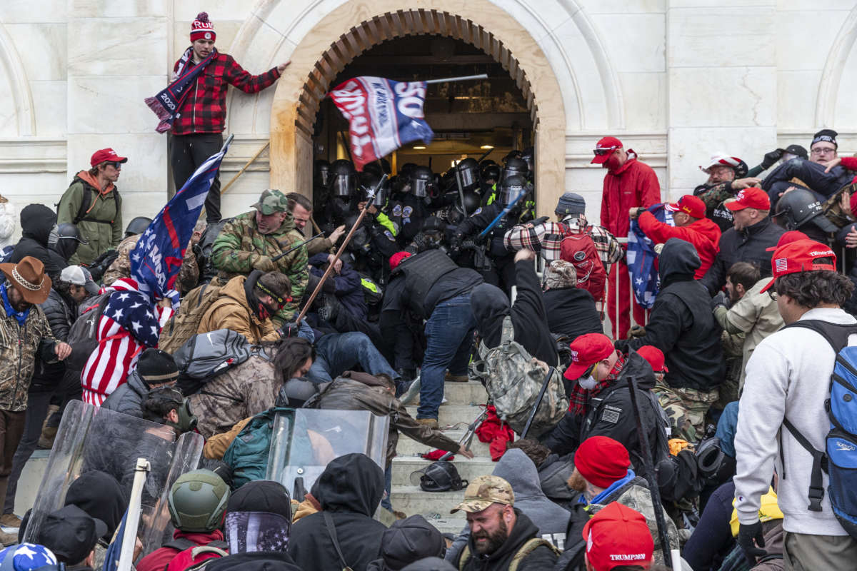Trump loyalists clash with police trying to enter Capitol building through the front doors on January 6, 2021, in Washington, D.C.