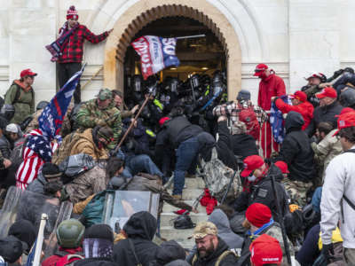 Trump loyalists clash with police trying to enter Capitol building through the front doors on January 6, 2021, in Washington, D.C.