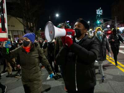 Demonstrators march through Brooklyn, New York during a protest against the current administration on January 7, 2021, a day after pro-Trump mob stormed and trashed the Capitol.