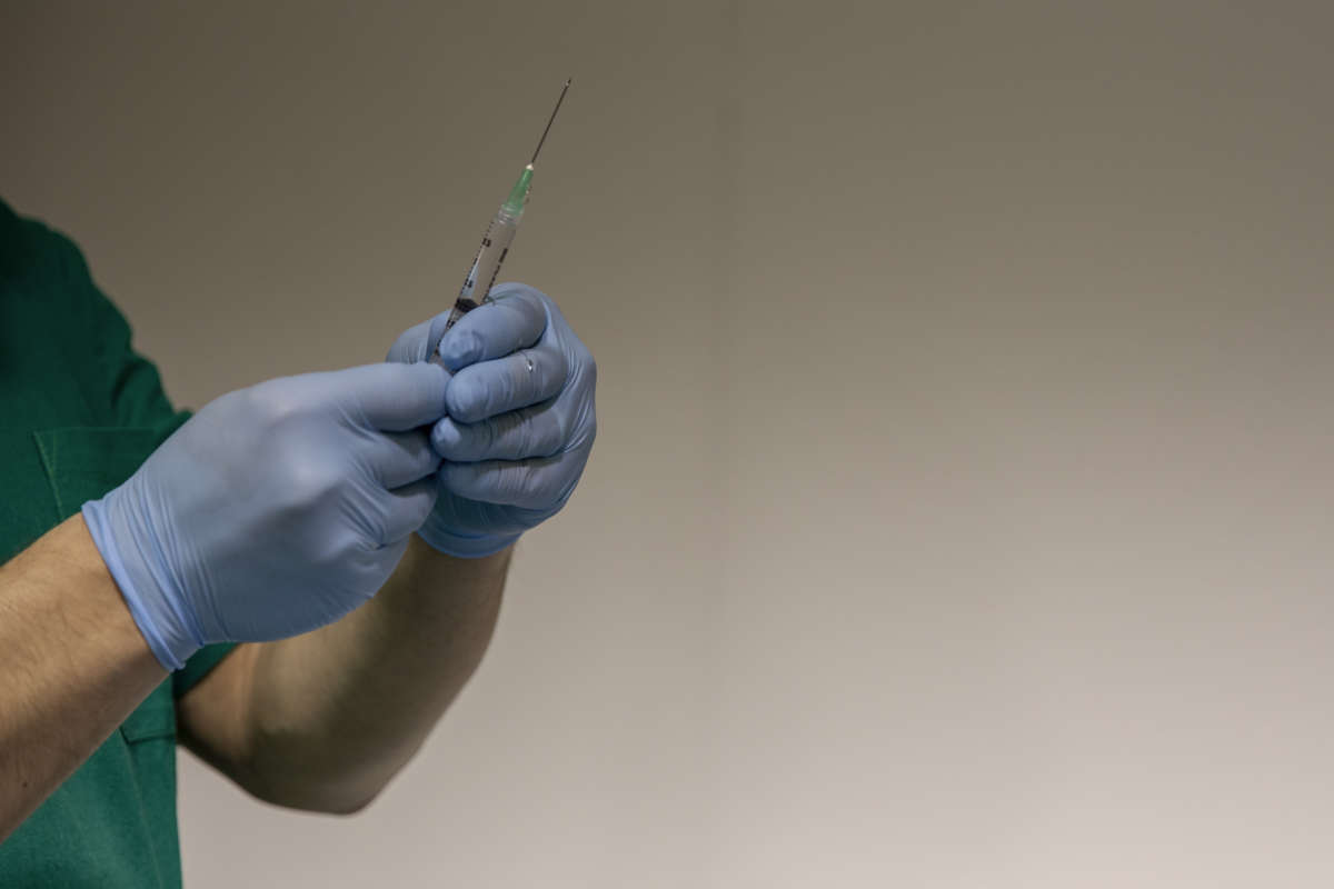 Health workers prepare doses of the Pfizer-BioNTech COVID-19 vaccine inside the coronavirus disease vaccination centre set up at La Mostra D'Oltremare in Naples, Italy, on January 9, 2021.