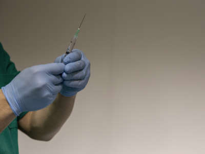 Health workers prepare doses of the Pfizer-BioNTech COVID-19 vaccine inside the coronavirus disease vaccination centre set up at La Mostra D'Oltremare in Naples, Italy, on January 9, 2021.