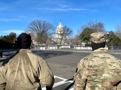 National Guard soldiers guard the grounds of the U.S. Capitol from behind a security fence in Washington, D.C., on January 9, 2021.