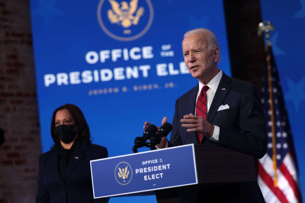 President-elect Joe Biden speaks as Vice President-elect Kamala Harris looks on during day two of laying out his plan on combating the coronavirus at the Queen theater January 15, 2021, in Wilmington, Delaware.