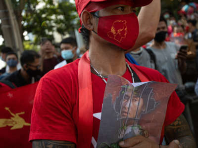 NLD supporter holds up a picture of leader Aung San Suu Kyi during a protest against the military coup in Burma (also known as Myanmar) outside its embassy in Thailand on February 1, 2021, in Bangkok, Thailand.